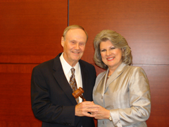 Robin Robinson (right) passes the gavel to Ed Blakeslee.